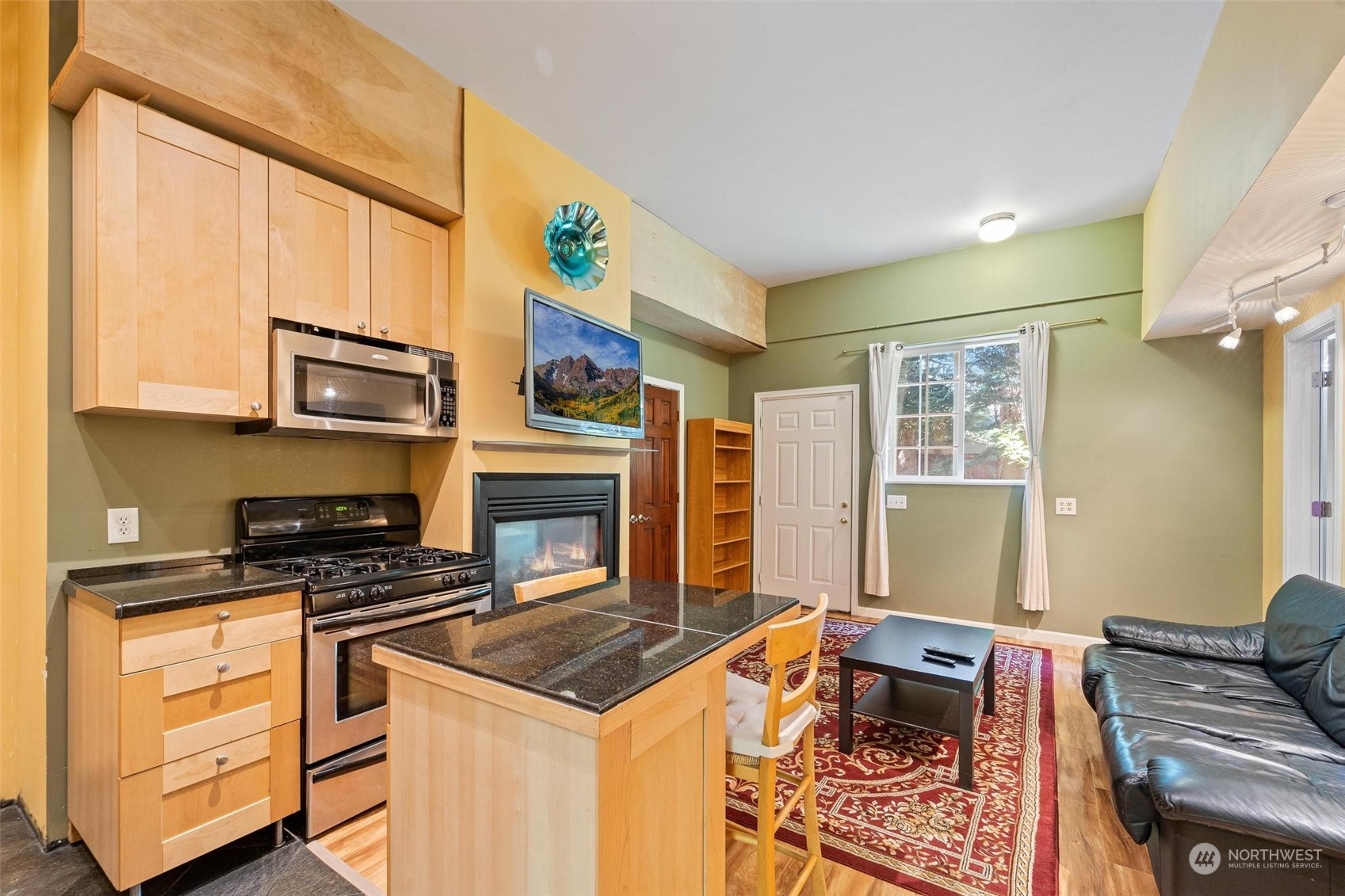 23220 49th Avenue Southeast Bothell, WA 98021 - Photo 27 of 40 a kitchen with stainless steel appliances granite countertop a stove and a microwave