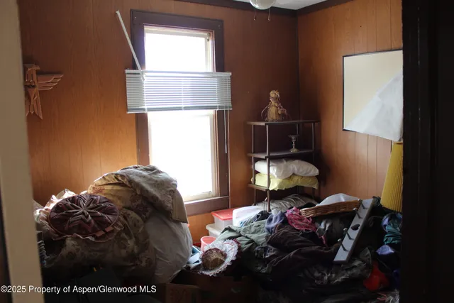 a living room with a bed and a window