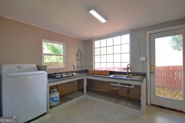 a kitchen that has a sink and a stove in it
