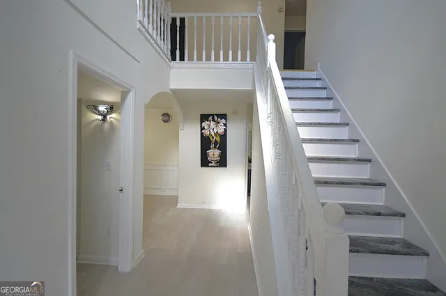 a view of a hallway with wooden floor and entryway