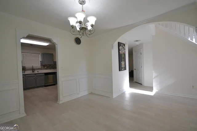 a view of a kitchen with a sink and dishwasher cabinets