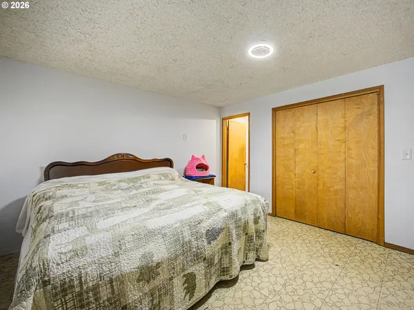 a bedroom with a bed and a television