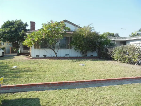 a view of swimming pool with lawn chairs and plants
