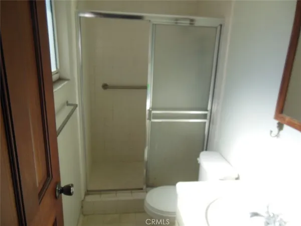 a bathroom with a shower and a toilet