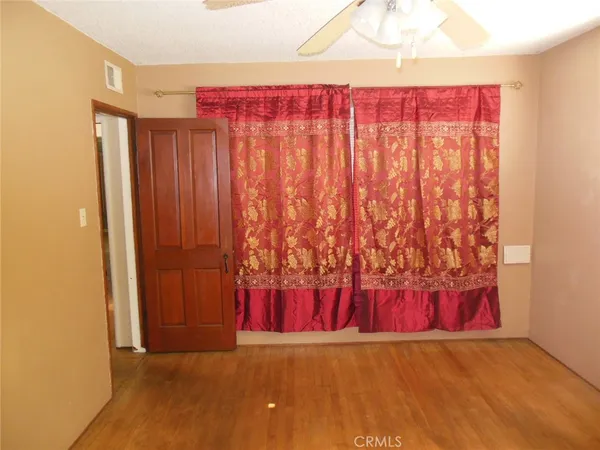 a view of a room with a wooden door and a window