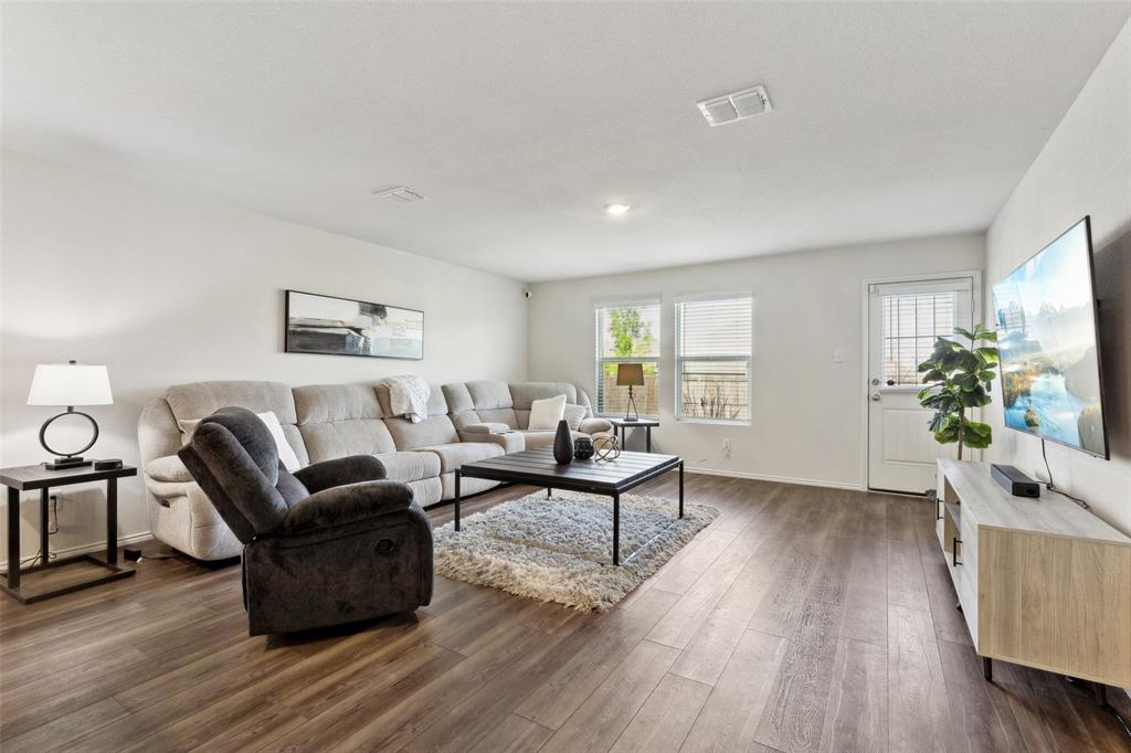 425 Sweetshade Lane Princeton, TX 75407 - Photo 11 of 29 a living room with furniture and a wooden floor