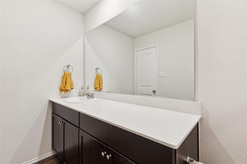 425 Sweetshade Lane Princeton, TX 75407 - Photo 17 of 29 a bathroom with a sink and a mirror