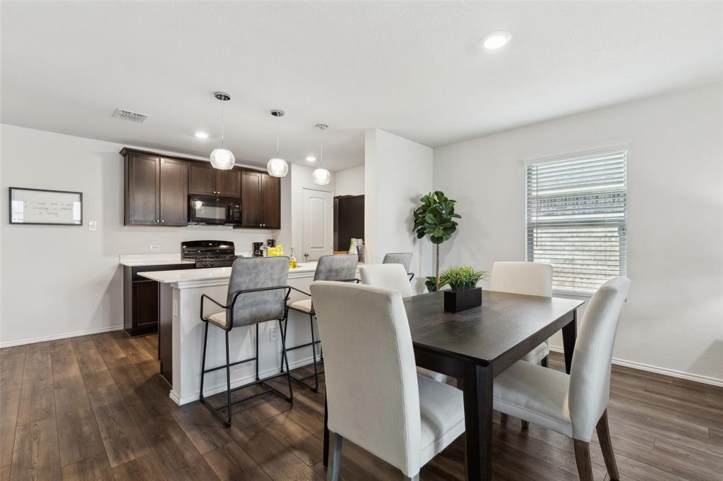 425 Sweetshade Lane Princeton, TX 75407 - Photo 8 of 29 a view of a dining room with furniture and wooden floor