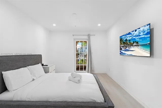 a bedroom with a large bed and a window