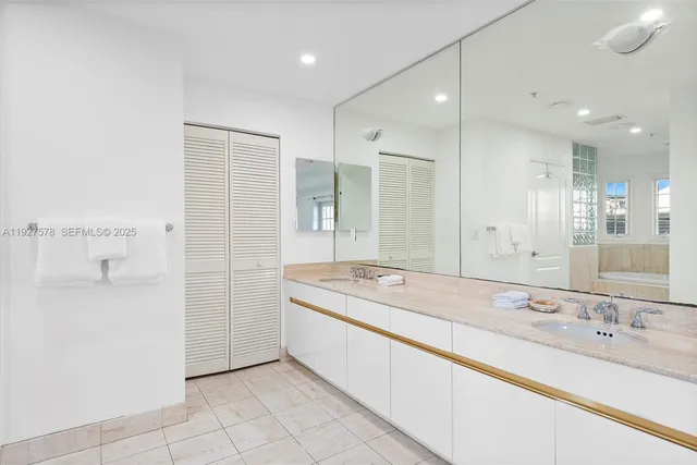 a bathroom with a granite countertop sink mirror and a