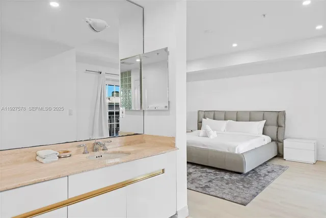 a spacious bathroom with a granite countertop sink and a mirror