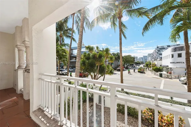 a view of a balcony with a palm tree