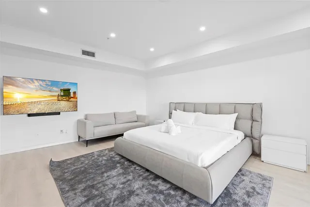 a bedroom with a bed and couch