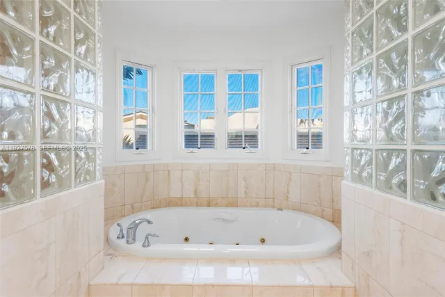 a white bath tub sitting next to a shower