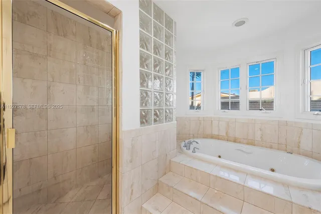 a bathroom with a bathtub and shower
