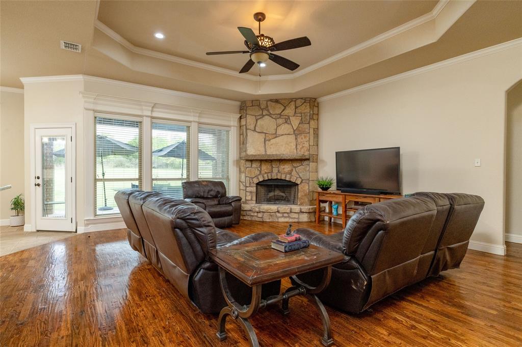 208 Ellis Creek Drive Weatherford, TX 76085 - Photo 12 of 40 a living room with furniture and a flat screen tv