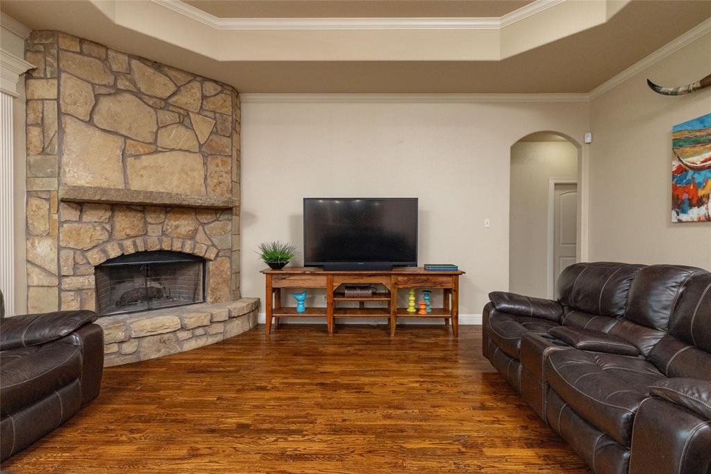 208 Ellis Creek Drive Weatherford, TX 76085 - Photo 13 of 40 a living room with furniture or flat screen tv and a fireplace