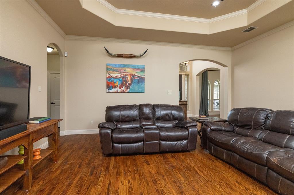 208 Ellis Creek Drive Weatherford, TX 76085 - Photo 14 of 40 a living room with furniture and a flat screen tv