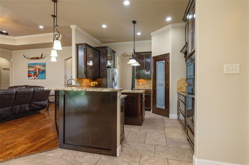 208 Ellis Creek Drive Weatherford, TX 76085 - Photo 16 of 40 a kitchen with stainless steel appliances granite countertop a refrigerator and a sink