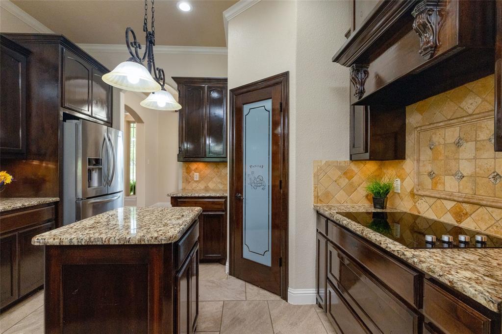 208 Ellis Creek Drive Weatherford, TX 76085 - Photo 18 of 40 a kitchen with stainless steel appliances granite countertop a sink and a refrigerator