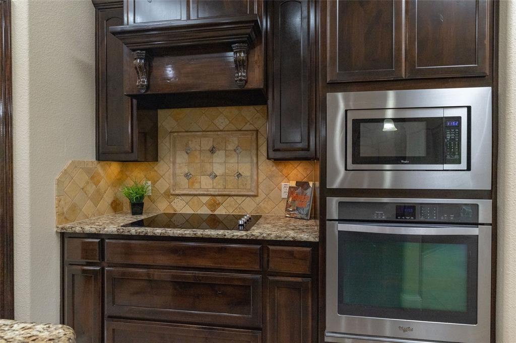 208 Ellis Creek Drive Weatherford, TX 76085 - Photo 19 of 40 a kitchen with granite countertop cabinets stove and oven