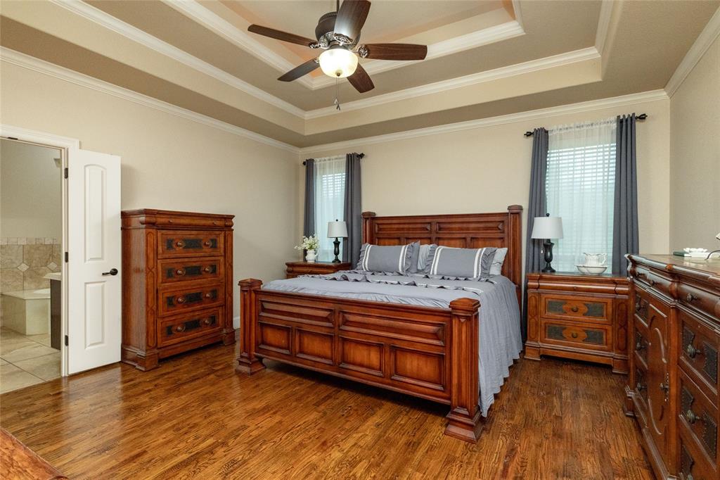 208 Ellis Creek Drive Weatherford, TX 76085 - Photo 23 of 40 a bedroom with a bed and a dresser