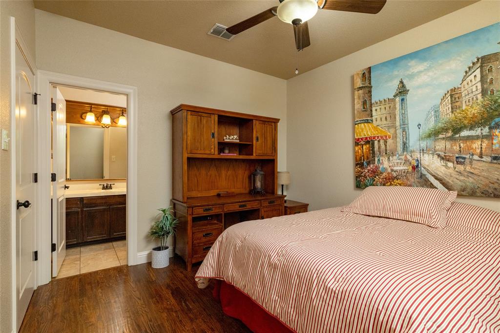 208 Ellis Creek Drive Weatherford, TX 76085 - Photo 27 of 40 a bedroom with a bed and a television