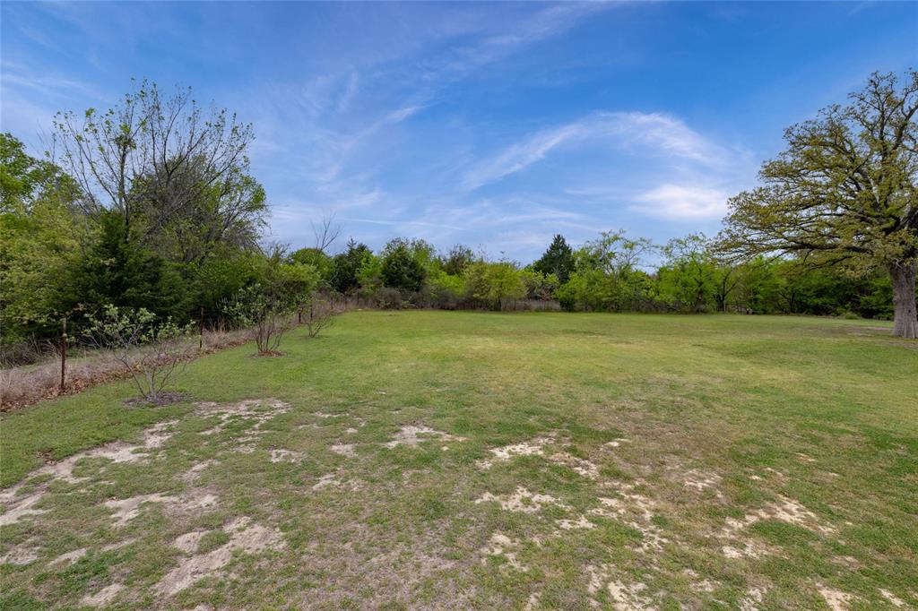 208 Ellis Creek Drive Weatherford, TX 76085 - Photo 34 of 40 a view of a field with an trees