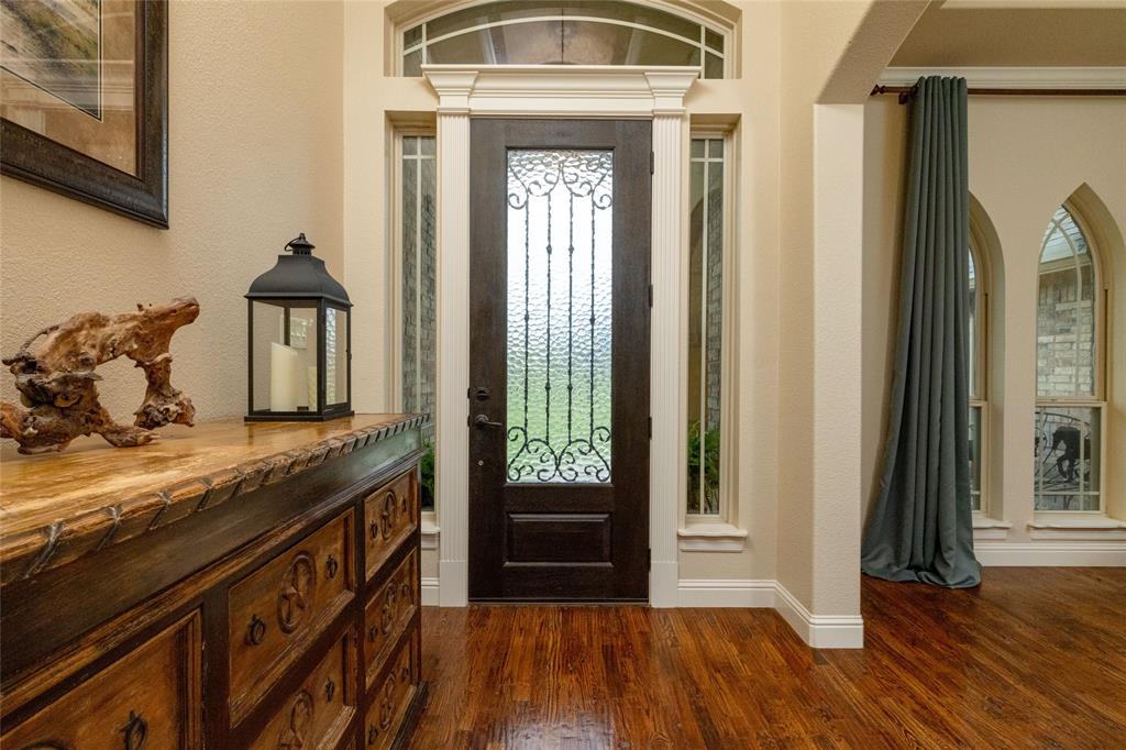 208 Ellis Creek Drive Weatherford, TX 76085 - Photo 7 of 40 a view of a hallway view with wooden floor and staircase