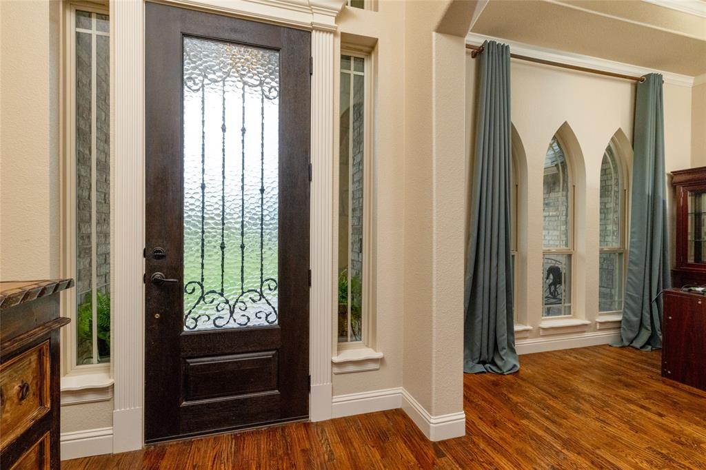 208 Ellis Creek Drive Weatherford, TX 76085 - Photo 8 of 40 a view of walk in closet with wooden floor