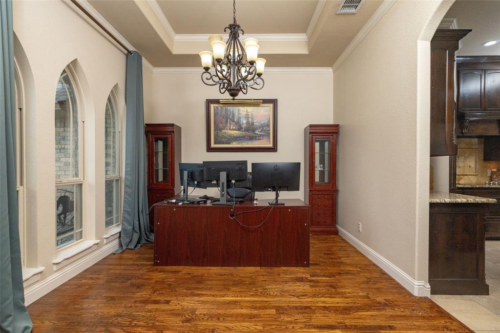 208 Ellis Creek Drive Weatherford, TX 76085 - Photo 9 of 40 a living room with fireplace furniture and a chandelier