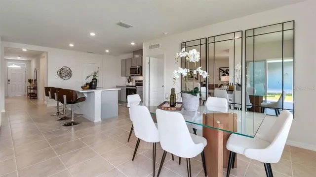 a dining room with furniture and a floor to ceiling window