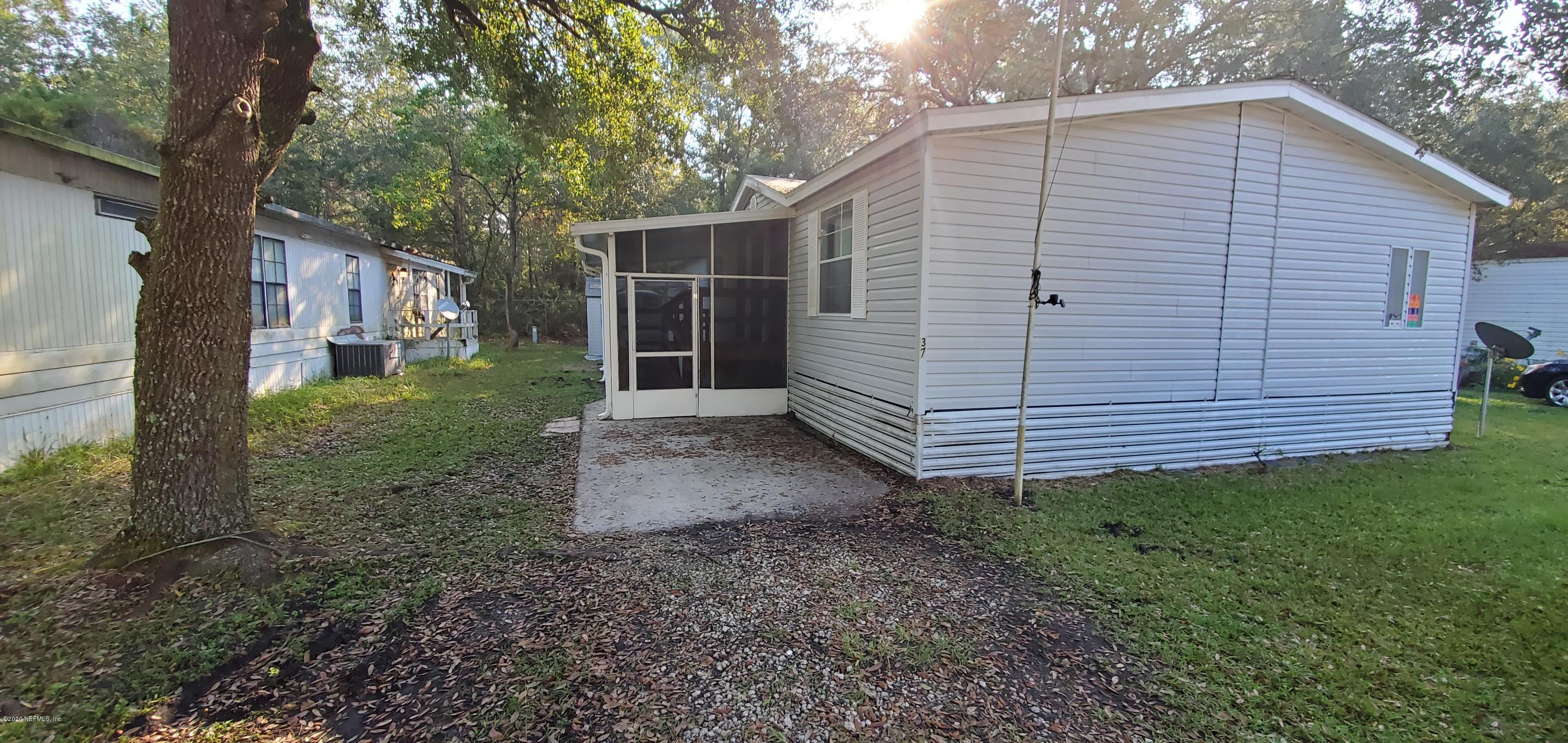 a view of a small house with a yard