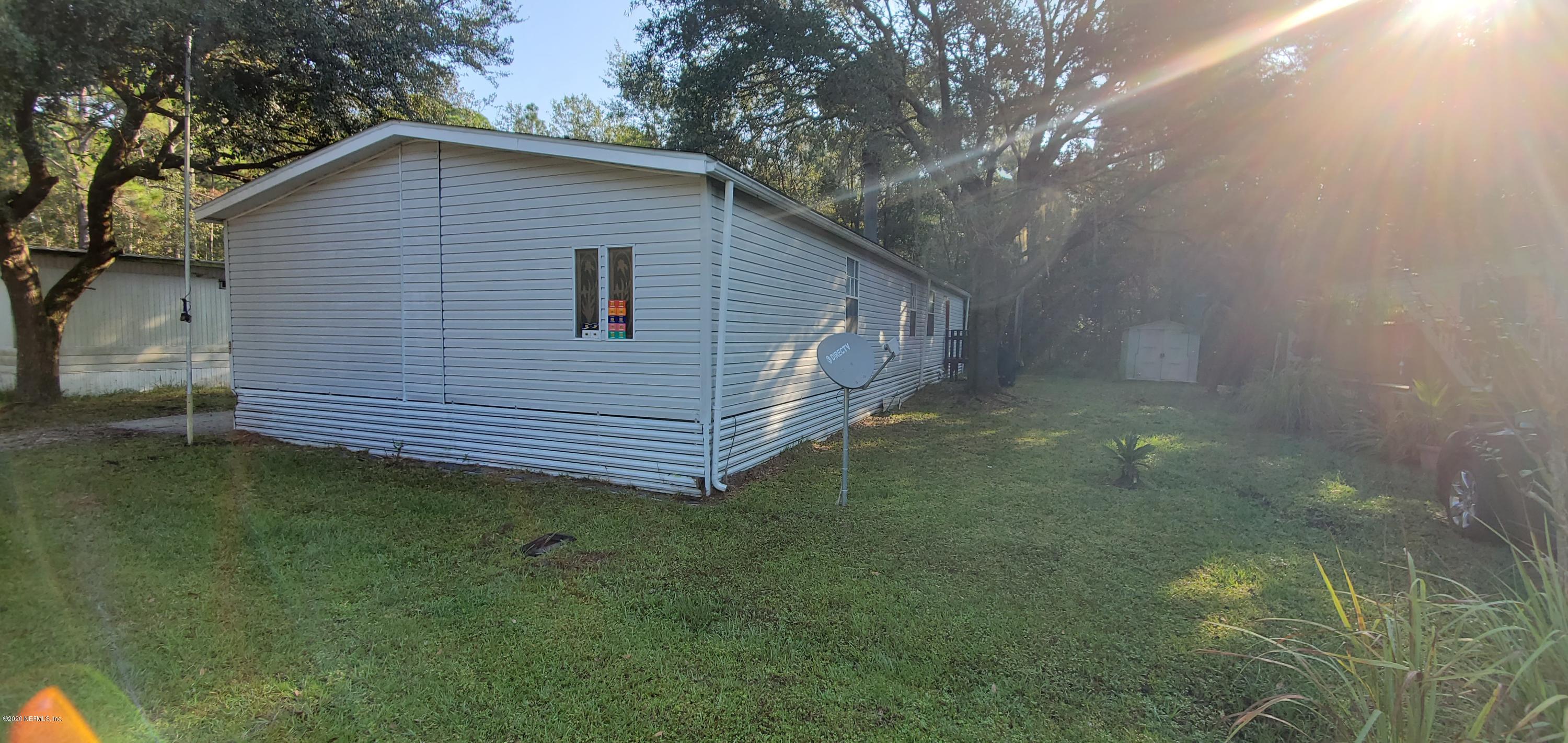 8917 Noroad, Unit 37 Jacksonville, FL 32210 - Photo 2 of 15 a backyard of a house with lots of green space