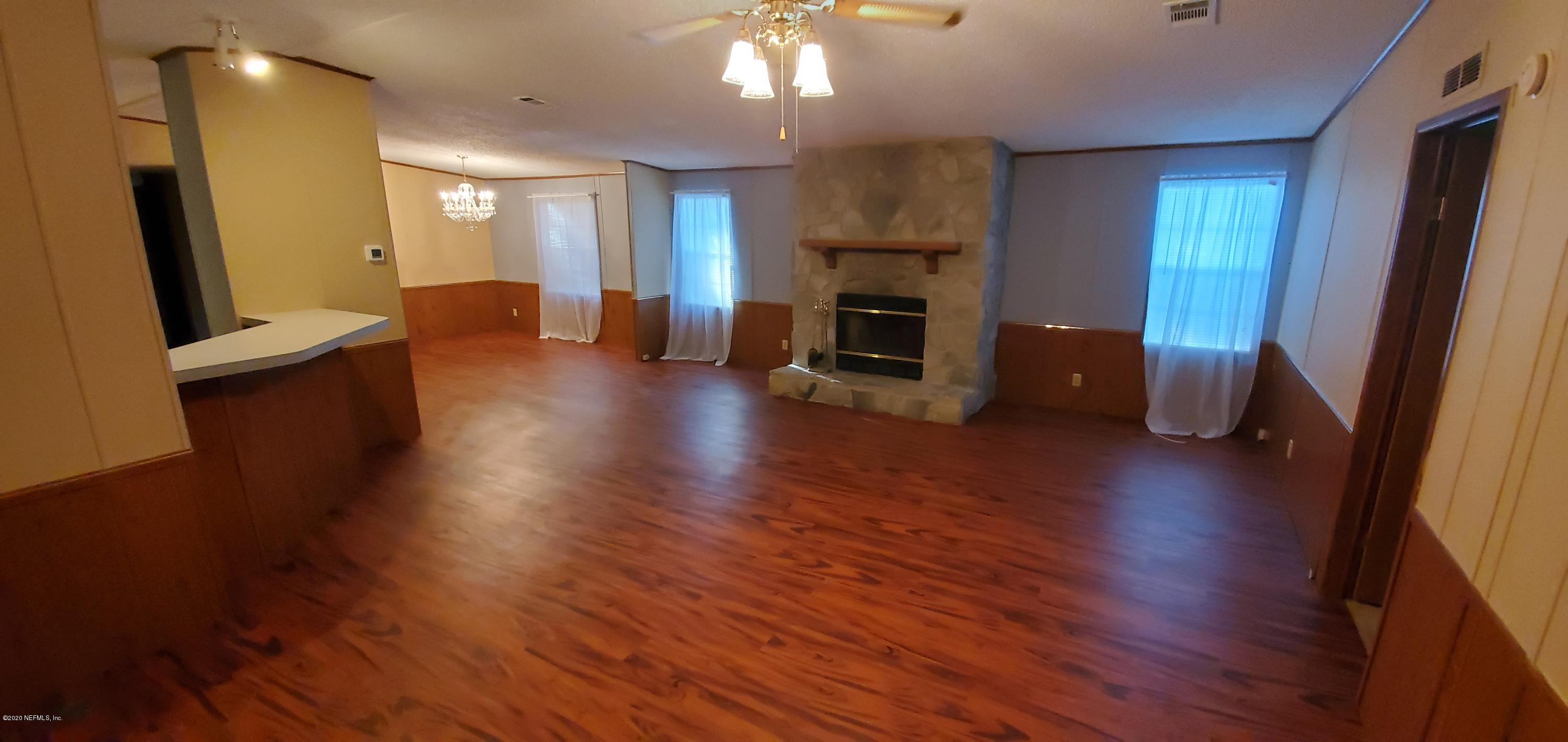 8917 Noroad, Unit 37 Jacksonville, FL 32210 - Photo 4 of 15 a view of a livingroom with furniture wooden floor and a fireplace