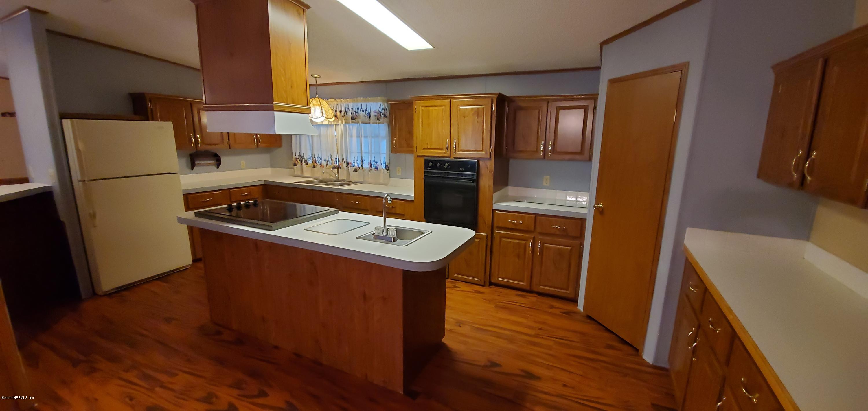 8917 Noroad, Unit 37 Jacksonville, FL 32210 - Photo 7 of 15 a kitchen with a refrigerator sink and stove