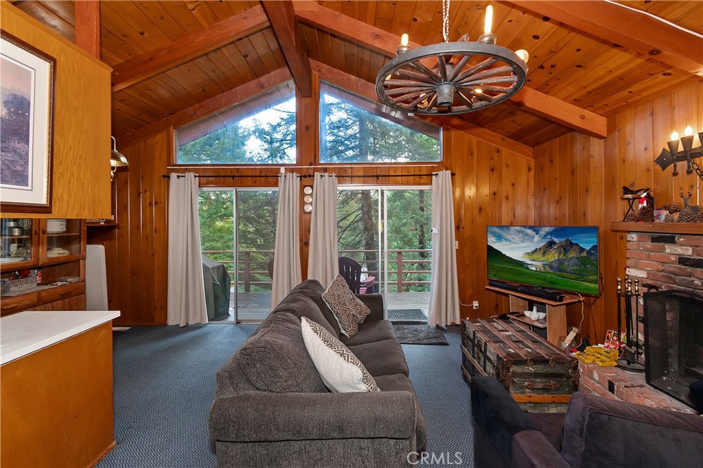 558 Rose Twin Peaks, CA 92391 - Photo 11 of 31 a living room with furniture a flat screen tv and a floor to ceiling window