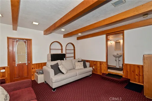 a living room with furniture and a ceiling fan