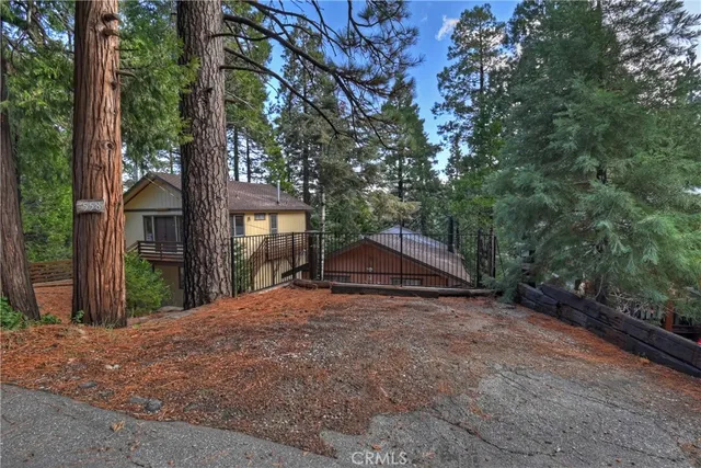 a view of a house with a tree in front of it