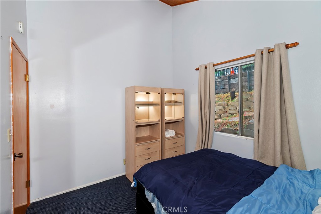 558 Rose Twin Peaks, CA 92391 - Photo 8 of 31 a bedroom with a bed and a window