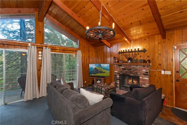 a living room with furniture a floor to ceiling window and a flat screen tv