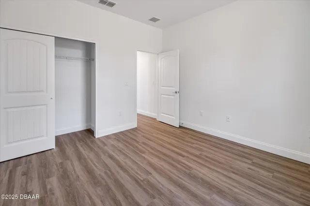a view of a room with wooden floor