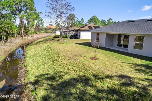 a blue swimming pool is in front of a house