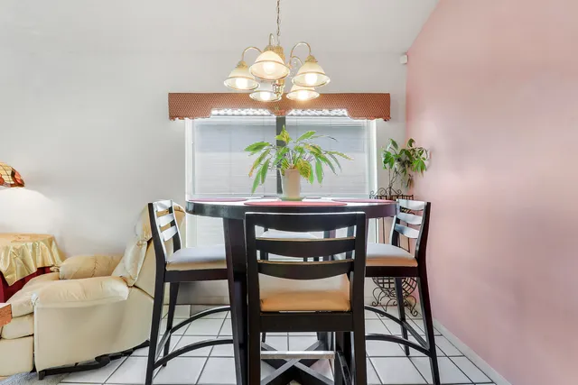 a dining room with furniture and chandelier