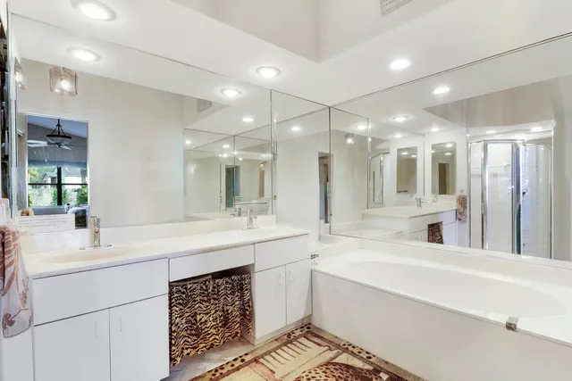 a bathroom with a sink double vanity and a large mirror