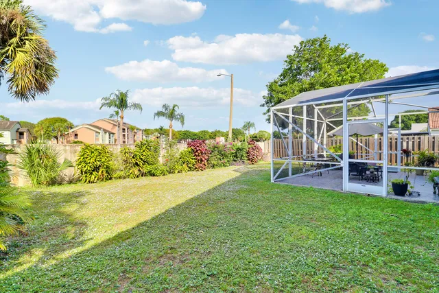 a view of a house with backyard porch and sitting area