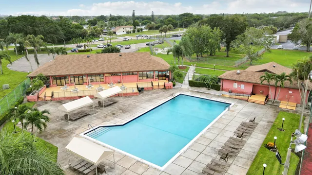 an aerial view of a house with a yard basket ball court and outdoor seating