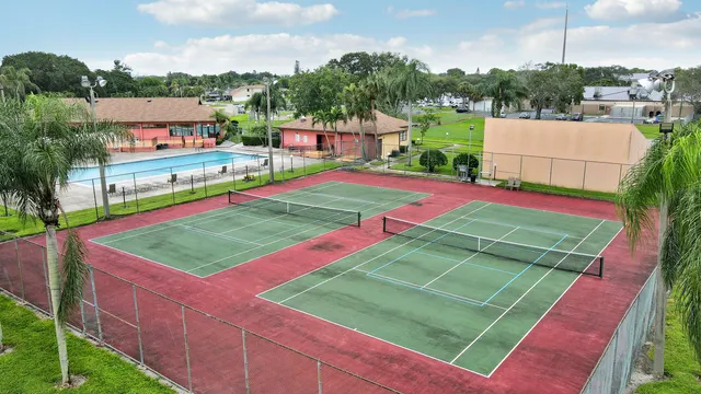 a green field with lots of tress in it