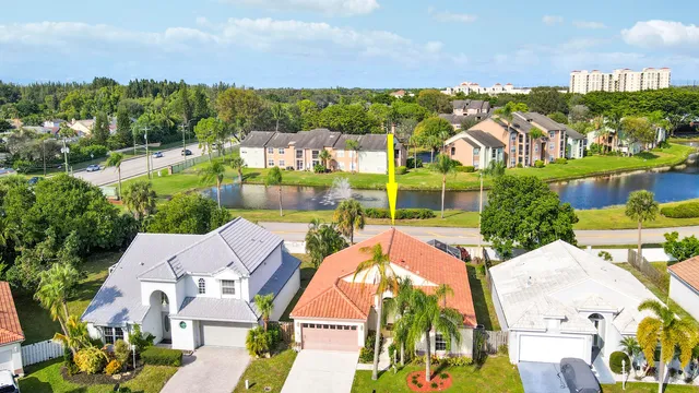 an aerial view of residential houses with outdoor space and swimming pool