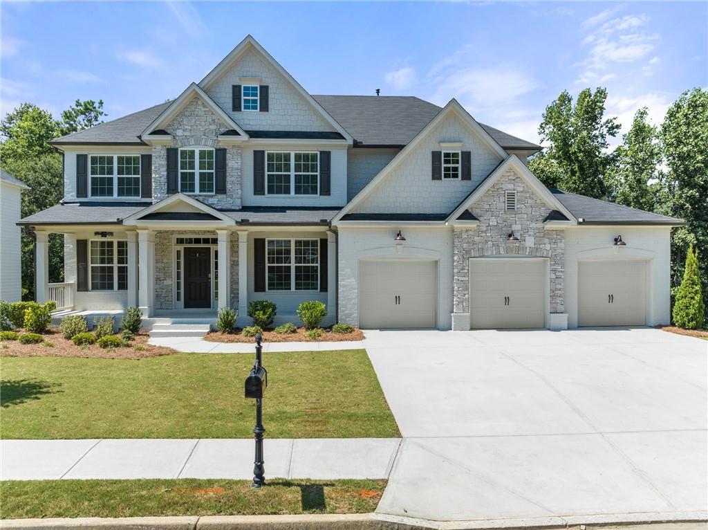 6180 Bridge Fair Road Cumming, GA 30028 - Photo 1 of 1 a front view of a house with a yard